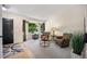 Bright living room with large window, neutral carpet, and stylish furnishings, perfect for relaxation at 5750 S Youngfield St, Littleton, CO 80127