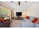Inviting living room with large windows, comfortable seating, and a stylish entertainment center with a cozy fireplace at 5750 S Youngfield St, Littleton, CO 80127