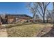 Spacious backyard with brick home, grill, and beautiful mature trees at 345 S Forest St, Denver, CO 80246