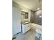 A bathroom features a vanity with a sink, a tub shower, gray tile, and a toilet at 345 S Forest St, Denver, CO 80246