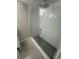 Modern bathroom shower with grey tile floor and white tile backsplash at 345 S Forest St, Denver, CO 80246