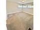 A bright bedroom features three windows and neutral-colored walls and carpet at 345 S Forest St, Denver, CO 80246