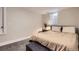 Cozy bedroom featuring neutral tones, carpet, a comfortable bed, and a side table with a lamp at 345 S Forest St, Denver, CO 80246
