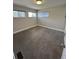 A bright bedroom features three windows and neutral-colored walls and carpet at 345 S Forest St, Denver, CO 80246