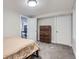 Bedroom with carpet, two white doors, a chest of drawers, and a window at 345 S Forest St, Denver, CO 80246