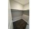 A walk-in closet features neutral colored walls, carpet, and a shelf for storage at 345 S Forest St, Denver, CO 80246
