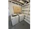 Functional laundry room with washer, dryer, utility sink, and shelving at 345 S Forest St, Denver, CO 80246