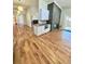 Open-concept living area featuring hardwood floors, modern lighting, and an adjacent kitchen at 345 S Forest St, Denver, CO 80246