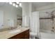 Bathroom with granite countertops, a dark wood vanity, and a shower with decorative tile at 1671 W Canal Cir # 221, Littleton, CO 80120