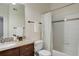 Bathroom with a granite countertop, a dark wood vanity, and a shower with decorative tile at 1671 W Canal Cir # 221, Littleton, CO 80120