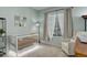 Cozy Bedroom with a crib, comfortable armchair, and large window with natural light at 1671 W Canal Cir # 221, Littleton, CO 80120