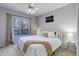 Inviting bedroom featuring a comfortable bed, ceiling fan, and large window with natural light at 1671 W Canal Cir # 221, Littleton, CO 80120