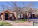 Exterior view of the community building with red brick and mature trees at 1671 W Canal Cir # 221, Littleton, CO 80120