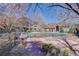 Outdoor community pool with adjacent building and trees in early spring at 1671 W Canal Cir # 221, Littleton, CO 80120