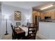 Inviting dining room features wood table, art and lighting that creates a warm and stylish space at 1671 W Canal Cir # 221, Littleton, CO 80120