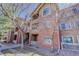 Two-story brick exterior with balconies and manicured landscaping at 1671 W Canal Cir # 221, Littleton, CO 80120
