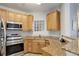 Well-equipped kitchen featuring stainless steel appliances, granite countertops, and wood cabinets at 1671 W Canal Cir # 221, Littleton, CO 80120