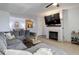 Spacious living room featuring a fireplace, large sectional couch, and bar cart at 1671 W Canal Cir # 221, Littleton, CO 80120