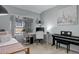 Home office with a desk, comfortable chair, and a bed for guests at 1671 W Canal Cir # 221, Littleton, CO 80120