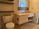 A simple bathroom featuring a dated vanity and toilet, providing an opportunity for a modern renovation to enhance comfort at 8779 Santa Fe Dr, Thornton, CO 80260