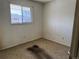 A modest bedroom with neutral carpeting and a window, offering a blank canvas for personalization and updates at 8779 Santa Fe Dr, Thornton, CO 80260