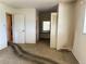 Spacious bedroom, carpeted floor, neutral walls, and potential for customization with a view into adjoining dressing area at 8779 Santa Fe Dr, Thornton, CO 80260