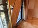 Damaged sliding glass door with broken glass, partially boarded up and covered by curtains, in need of immediate replacement at 8779 Santa Fe Dr, Thornton, CO 80260