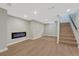 Finished basement with modern floors, recessed lighting, and a cozy electric fireplace at 1328 Holly St, Denver, CO 80220