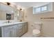 Renovated bathroom features dual vanity, new fixtures and bright lighting, offering a spa-like experience at 1328 Holly St, Denver, CO 80220