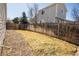 Spacious backyard with a mix of grass, landscaping, and a wooden fence at 12555 Birch Ave, Thornton, CO 80241