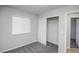 Bedroom with gray carpet, a closet, and a window with blinds for natural light at 12555 Birch Ave, Thornton, CO 80241