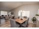 Elegant dining area with wood table, comfortable seating and a view into the living room at 12555 Birch Ave, Thornton, CO 80241