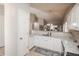 Bright open kitchen featuring granite countertops, white cabinets, and seamless integration with the dining area at 12555 Birch Ave, Thornton, CO 80241