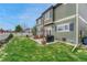 Green backyard with a concrete patio including an outdoor grilling area and grass at 1192 S Fultondale Cir, Aurora, CO 80018