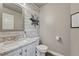 Chic half-bathroom featuring a white wood accent wall, a pedestal sink, and a toilet at 1192 S Fultondale Cir, Aurora, CO 80018