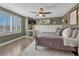 This bedroom boasts warm green walls, ceiling fan and bright window shutters at 1192 S Fultondale Cir, Aurora, CO 80018