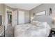 Inviting bedroom with a queen bed and decoratively adorned walls leading to an open doorway at 1192 S Fultondale Cir, Aurora, CO 80018