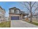 Charming two-story home with a stone facade, a two-car garage, and a covered front porch at 1192 S Fultondale Cir, Aurora, CO 80018