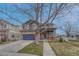 Charming two-story home with a stone facade, a two-car garage, and a covered front porch at 1192 S Fultondale Cir, Aurora, CO 80018