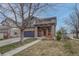 Charming two-story home with a stone facade, a two-car garage, and a covered front porch at 1192 S Fultondale Cir, Aurora, CO 80018