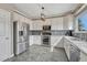 Modern kitchen with stainless steel appliances, white cabinets, and tiled backsplash at 1192 S Fultondale Cir, Aurora, CO 80018