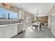 Open concept kitchen with view to dining area, french doors and the living room at 1192 S Fultondale Cir, Aurora, CO 80018