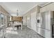 Open concept kitchen with appliances, dining area, view to the living room, and backyard access at 1192 S Fultondale Cir, Aurora, CO 80018