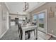 Eat-in kitchen with white cabinets, stainless steel appliances, and a farmhouse-style dining table at 1192 S Fultondale Cir, Aurora, CO 80018