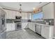Bright kitchen features white cabinets, stainless steel appliances, and elegant countertop at 1192 S Fultondale Cir, Aurora, CO 80018