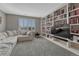 A comfortable living room boasts custom built-in bookshelves and neutral finishes at 1192 S Fultondale Cir, Aurora, CO 80018