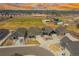 Scenic aerial view of homes with sports fields, parks, and playground in the community at 331 Josef Cir, Fort Lupton, CO 80621