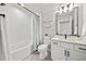 Bright bathroom with a tub-shower combo, modern fixtures, white cabinets, and a large mirror at 331 Josef Cir, Fort Lupton, CO 80621