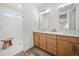 Bathroom featuring double sink vanity, quartz countertops and a tiled walk-in shower at 331 Josef Cir, Fort Lupton, CO 80621
