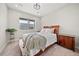 Cozy bedroom with plush carpet, queen bed, matching nightstands, and a large window overlooking the neighborhood at 331 Josef Cir, Fort Lupton, CO 80621